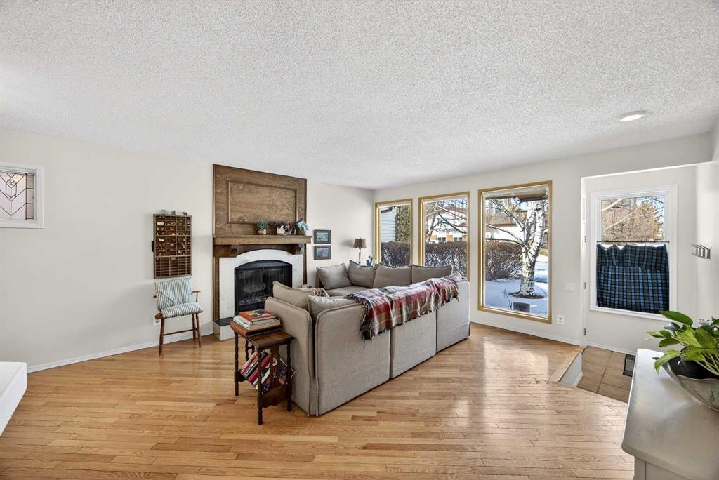 100 Strathcona Close Sw, Calgary, AB - Indoor Photo Showing Living Room With Fireplace