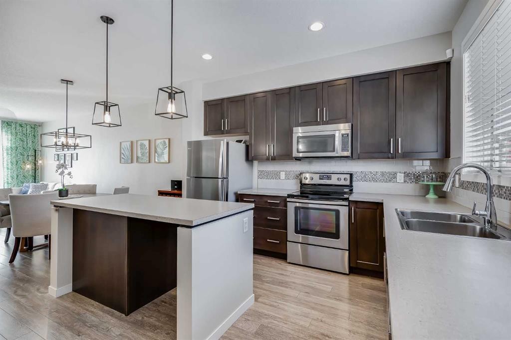 20 Copperpond Rise Se, Calgary, AB - Indoor Photo Showing Kitchen With Stainless Steel Kitchen With Double Sink With Upgraded Kitchen