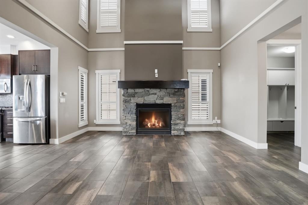 595 Panamount Boulevard Nw, Calgary, AB - Indoor Photo Showing Living Room With Fireplace