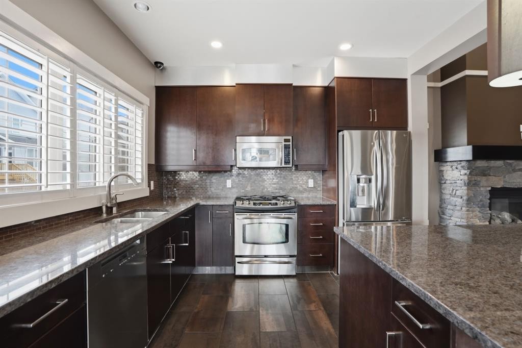 595 Panamount Boulevard Nw, Calgary, AB - Indoor Photo Showing Kitchen With Stainless Steel Kitchen With Double Sink With Upgraded Kitchen