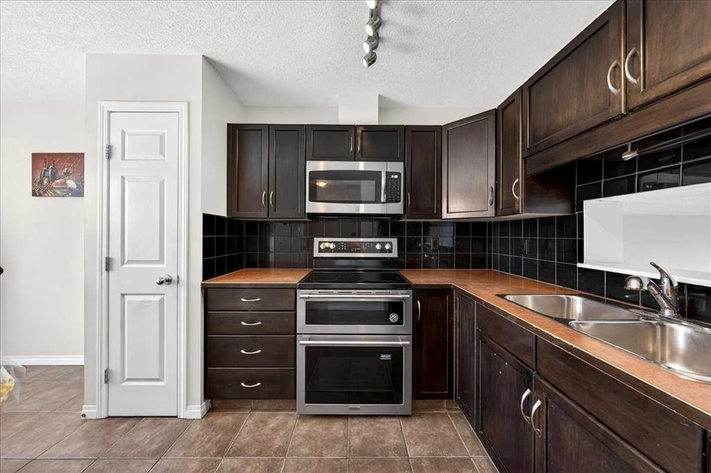 99 Copperfield Court Se, Calgary, AB - Indoor Photo Showing Kitchen With Double Sink