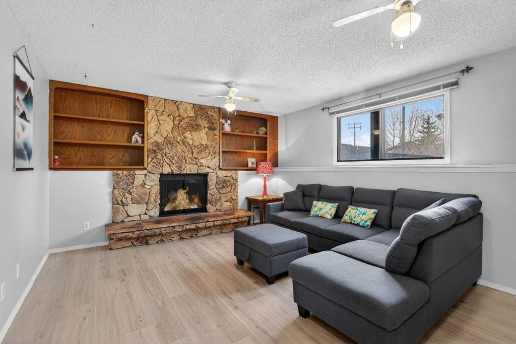 195 Fallswater Road Ne, Calgary, AB - Indoor Photo Showing Living Room With Fireplace