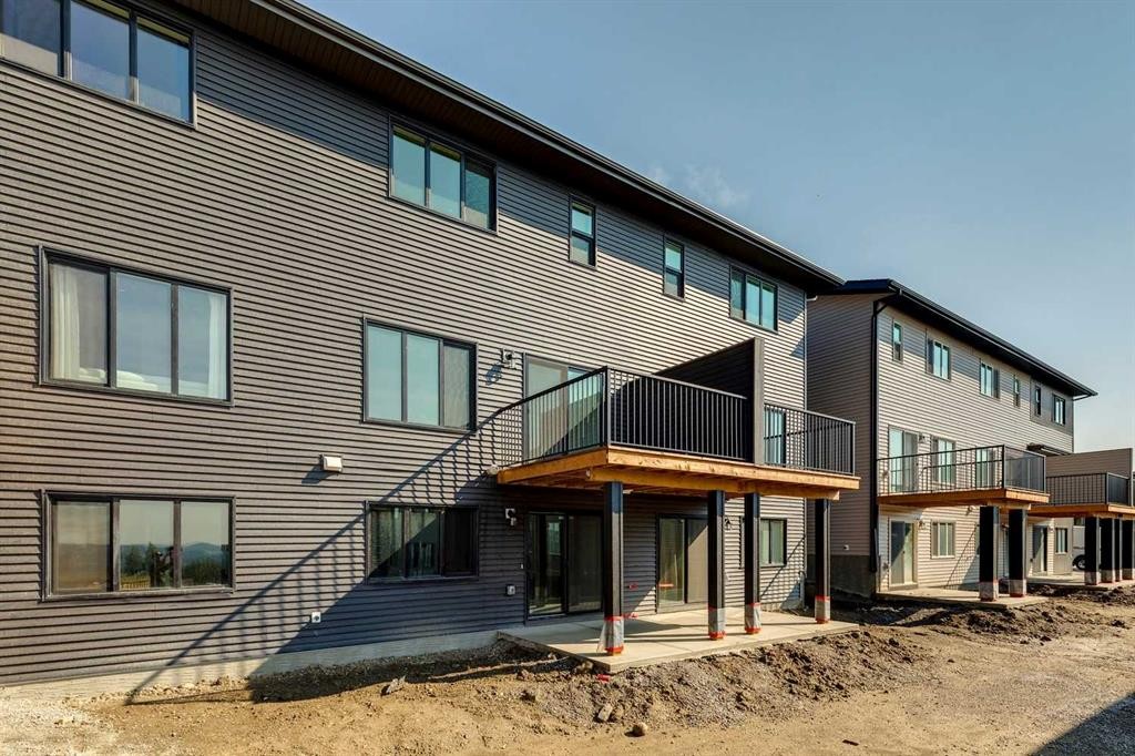 44 Heritage Manor, Cochrane, AB - Outdoor With Deck Patio Veranda With Exterior