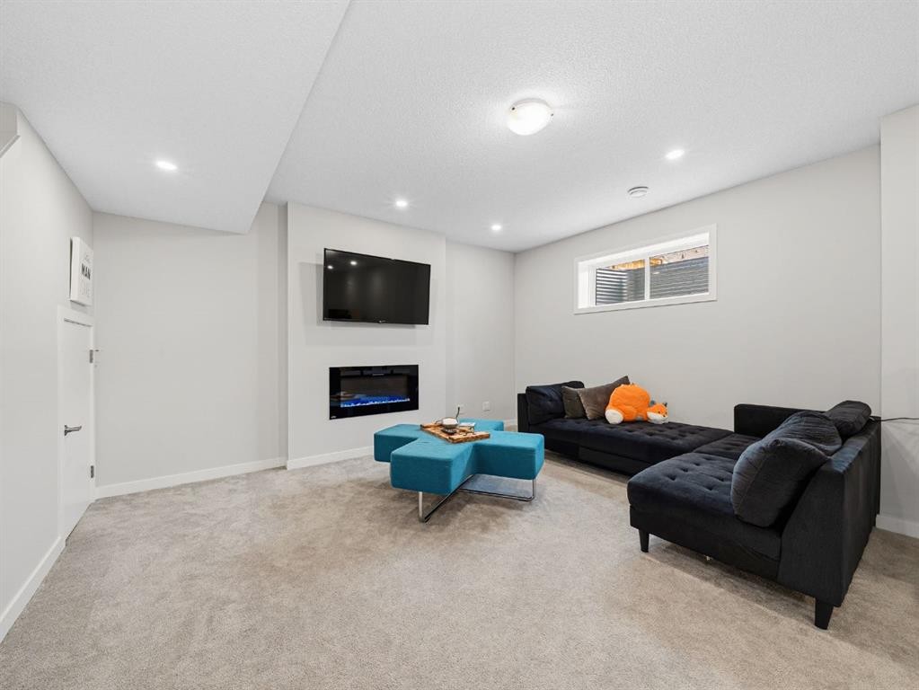 44 Masters Terrace Se, Calgary, AB - Indoor Photo Showing Other Room With Fireplace