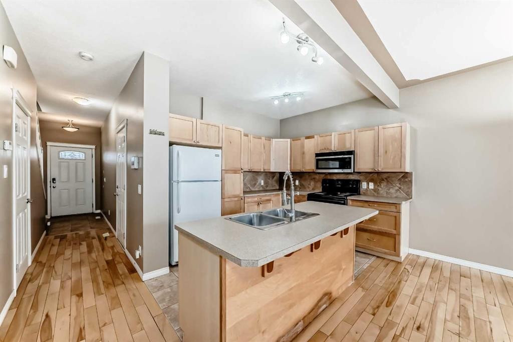 207-620 Luxstone Landing Sw, Airdrie, AB - Indoor Photo Showing Kitchen With Double Sink