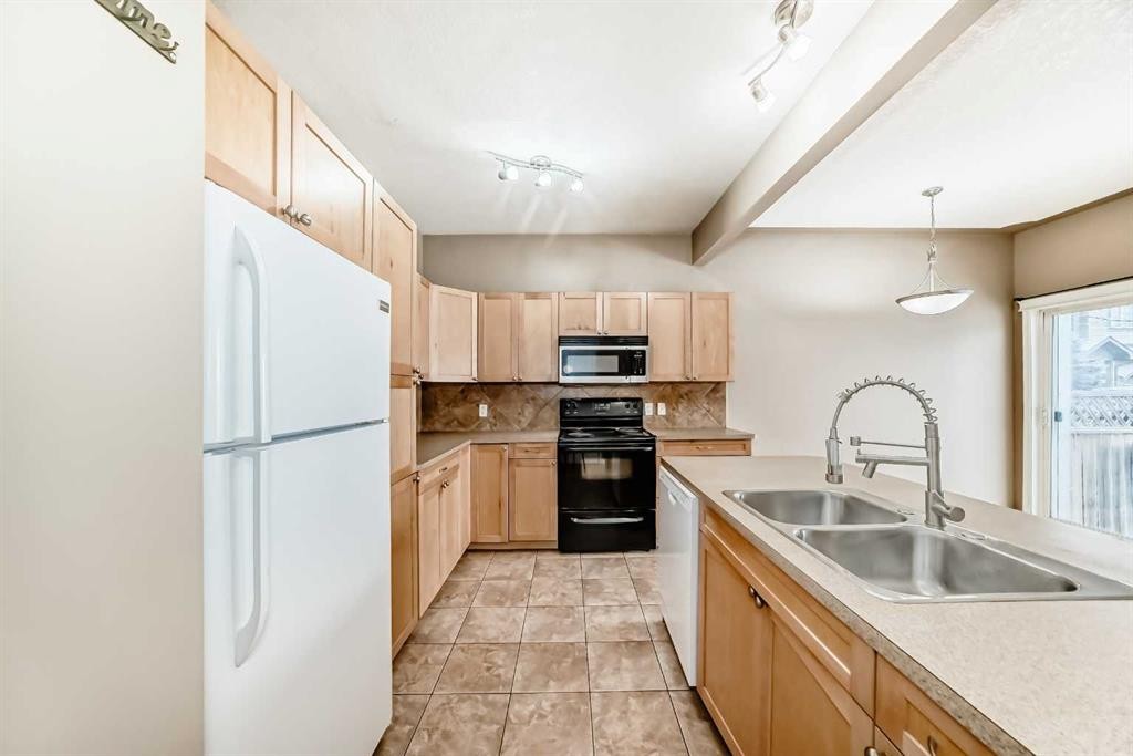 207-620 Luxstone Landing Sw, Airdrie, AB - Indoor Photo Showing Kitchen With Double Sink