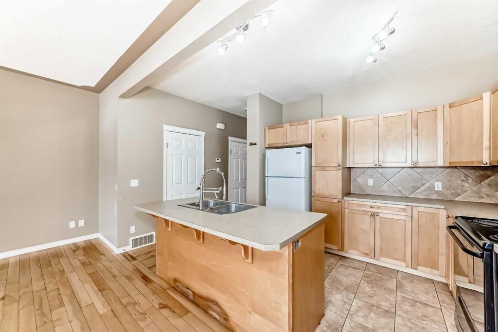 207-620 Luxstone Landing Sw, Airdrie, AB - Indoor Photo Showing Kitchen With Double Sink