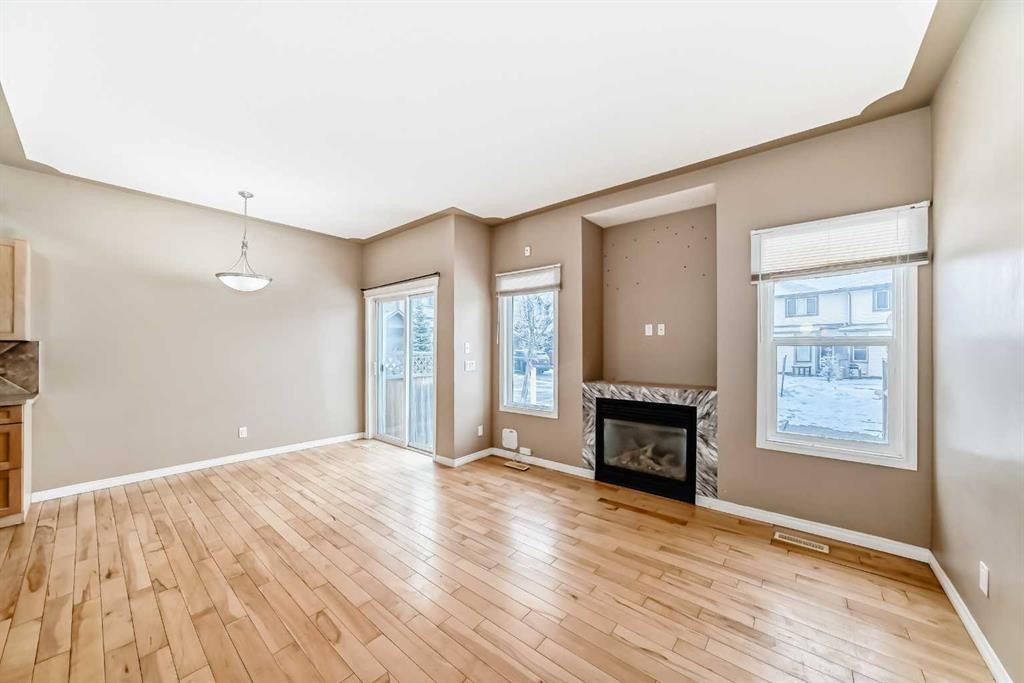207-620 Luxstone Landing Sw, Airdrie, AB - Indoor Photo Showing Living Room With Fireplace