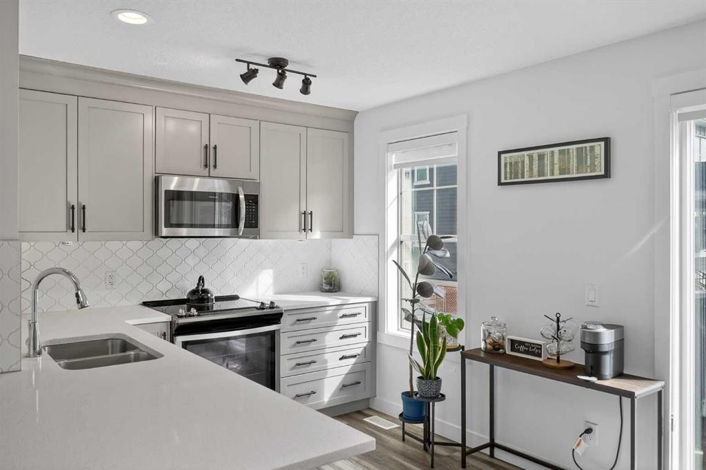103 Cranbrook Walk Se, Calgary, AB - Indoor Photo Showing Kitchen With Stainless Steel Kitchen With Double Sink With Upgraded Kitchen