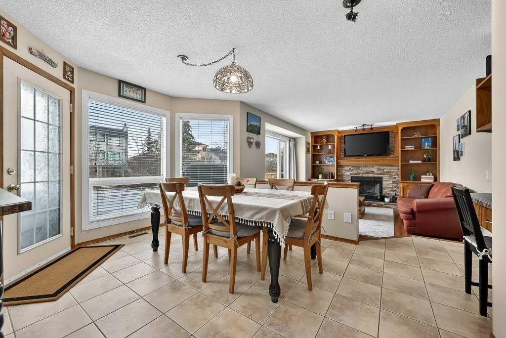 108 Hawkstone Close Nw, Calgary, AB - Indoor Photo Showing Dining Room With Fireplace