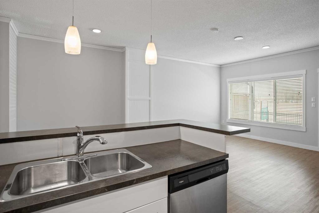 100-351 Monteith Drive Se, High River, AB - Indoor Photo Showing Kitchen With Double Sink