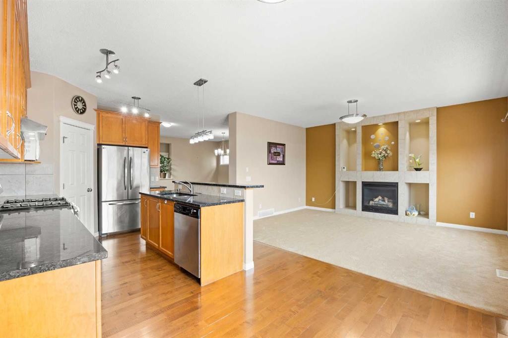 65 Panora Way Nw, Calgary, AB - Indoor Photo Showing Kitchen With Fireplace With Stainless Steel Kitchen