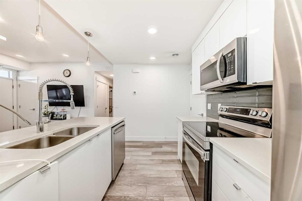 4697 Seton Drive Se, Calgary, AB - Indoor Photo Showing Kitchen With Stainless Steel Kitchen With Double Sink