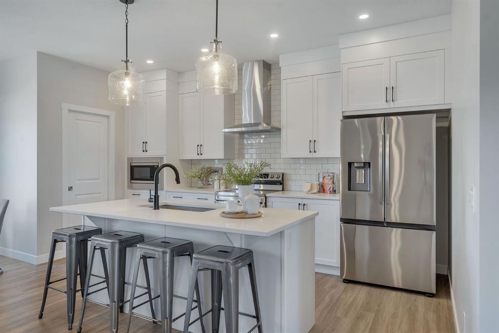 11 Fireside Common, Cochrane, AB - Indoor Photo Showing Kitchen With Stainless Steel Kitchen With Upgraded Kitchen