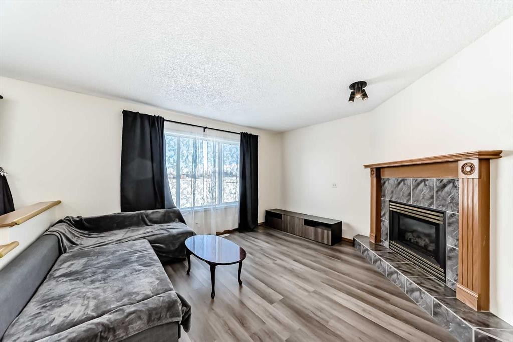 136 Citadel Crest Circle Nw, Calgary, AB - Indoor Photo Showing Living Room With Fireplace