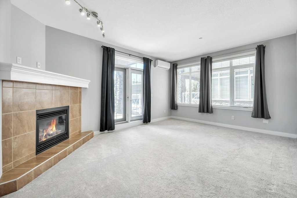 102-1005B Westmount Drive, Strathmore, AB - Indoor With Fireplace