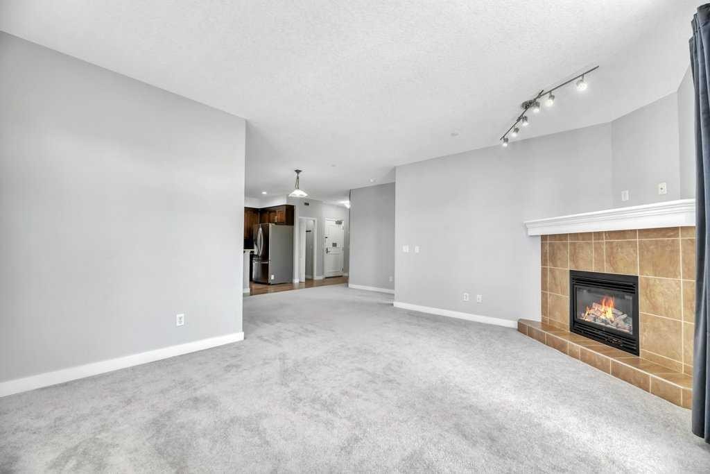 102-1005B Westmount Drive, Strathmore, AB - Indoor Photo Showing Living Room With Fireplace