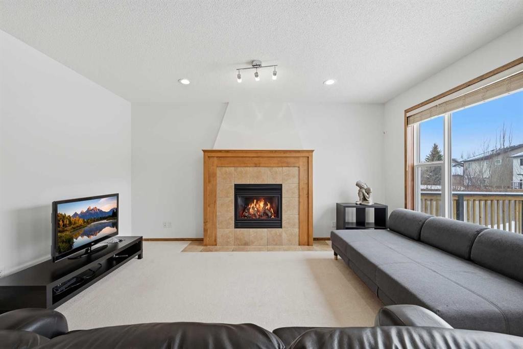 125 Panamount Heath Nw, Calgary, AB - Indoor Photo Showing Living Room With Fireplace