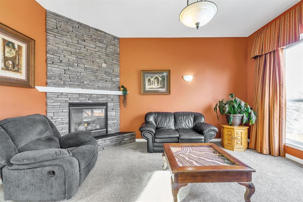 151 Hawkmere View, Chestermere, AB - Indoor Photo Showing Living Room With Fireplace
