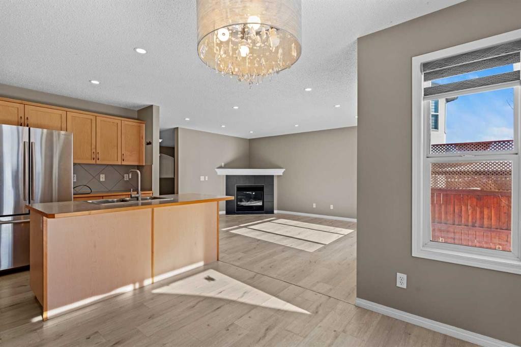 138 Saddlecrest Park Ne, Calgary, AB - Indoor Photo Showing Kitchen With Fireplace With Double Sink