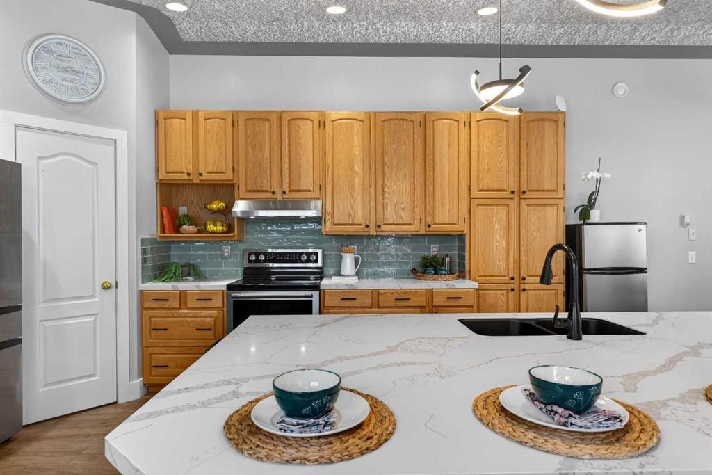 64 Foxwell Road Se, Calgary, AB - Indoor Photo Showing Kitchen With Stainless Steel Kitchen