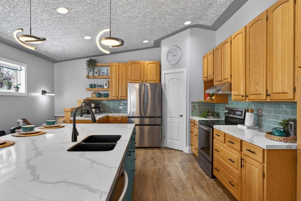 64 Foxwell Road Se, Calgary, AB - Indoor Photo Showing Kitchen With Stainless Steel Kitchen With Double Sink