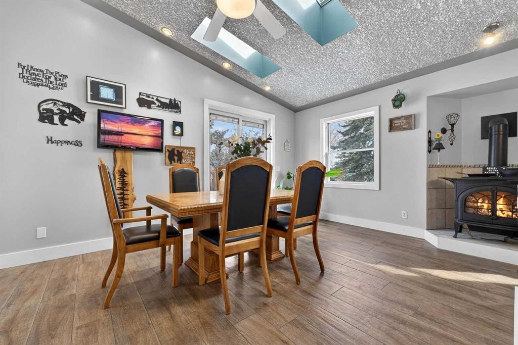 64 Foxwell Road Se, Calgary, AB - Indoor Photo Showing Dining Room With Fireplace
