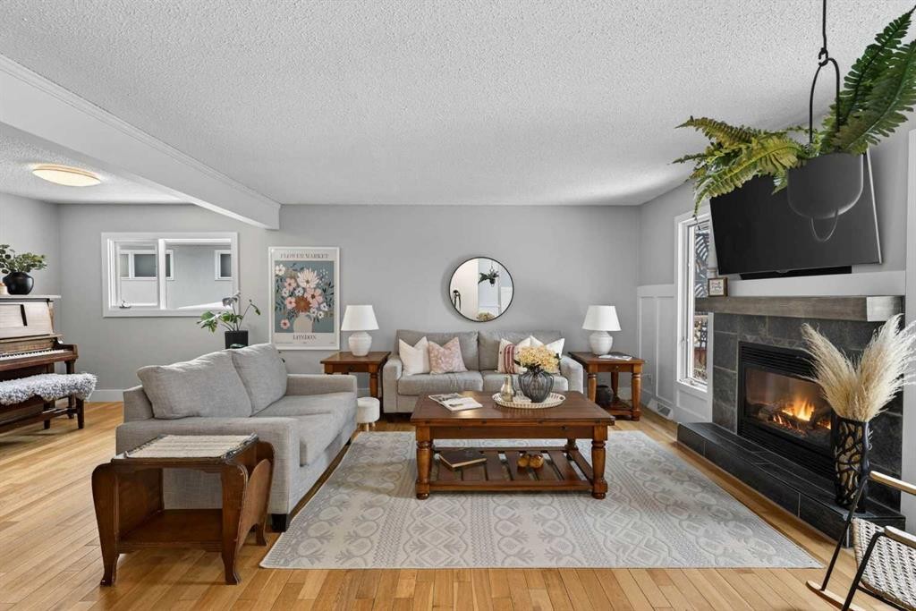 64 Foxwell Road Se, Calgary, AB - Indoor Photo Showing Living Room With Fireplace