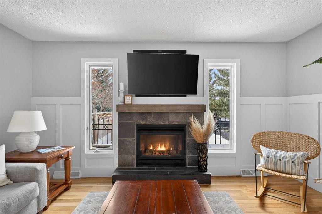 64 Foxwell Road Se, Calgary, AB - Indoor Photo Showing Living Room With Fireplace