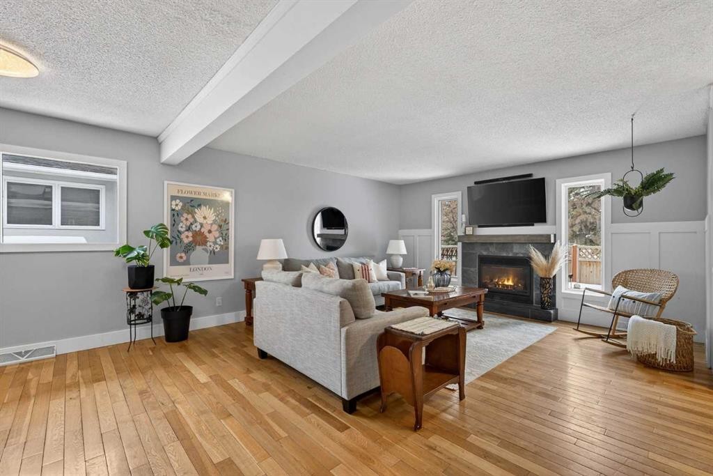 64 Foxwell Road Se, Calgary, AB - Indoor Photo Showing Living Room With Fireplace