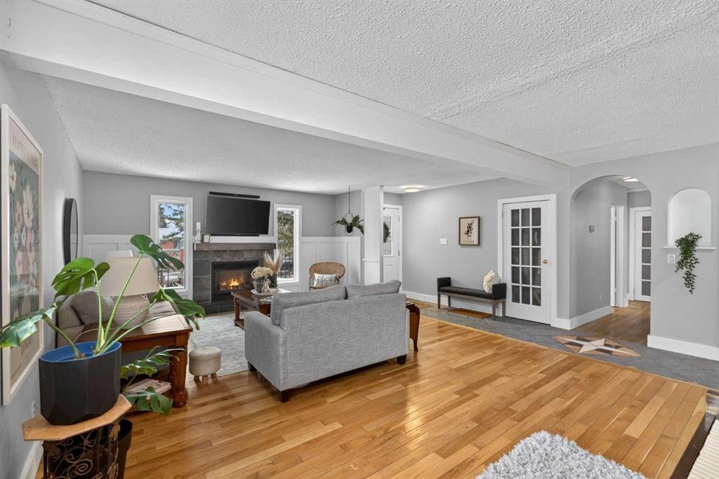 64 Foxwell Road Se, Calgary, AB - Indoor Photo Showing Living Room With Fireplace