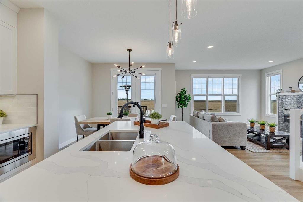 467 Kinniburgh Loop, Chestermere, AB - Indoor Photo Showing Kitchen With Fireplace With Double Sink With Upgraded Kitchen