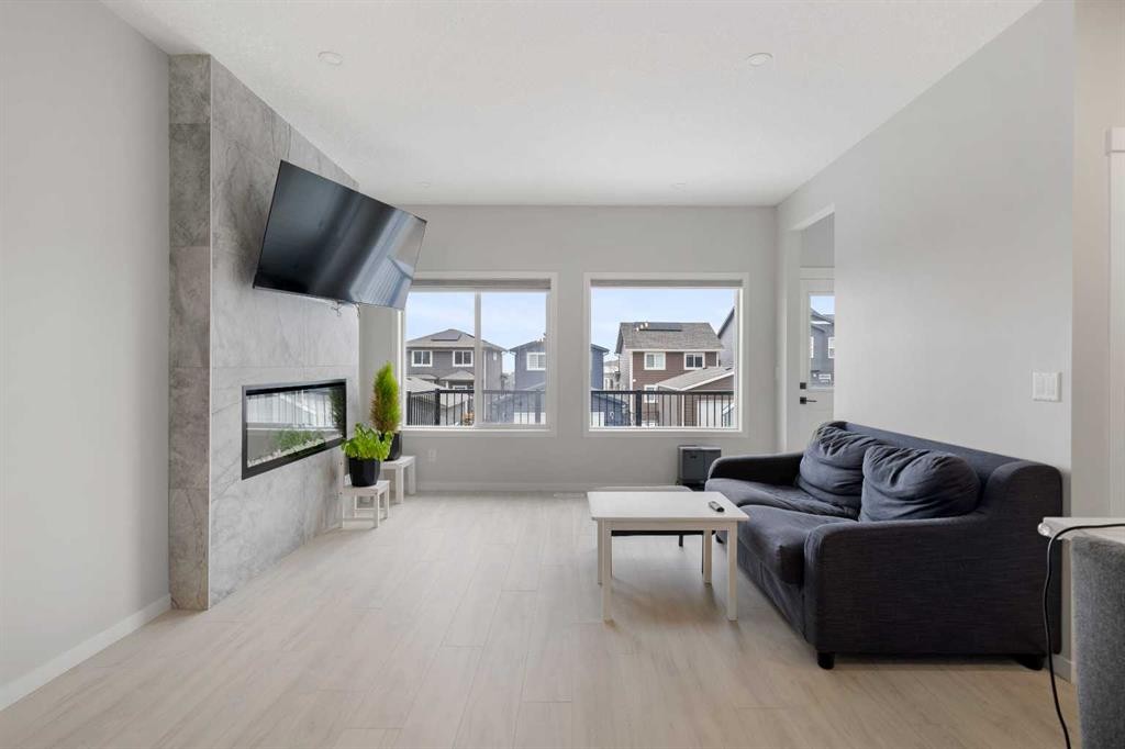 22 Edith Manor Nw, Calgary, AB - Indoor Photo Showing Living Room With Fireplace