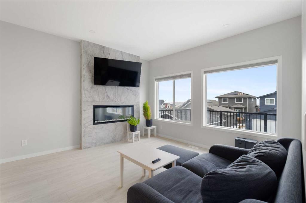 22 Edith Manor Nw, Calgary, AB - Indoor Photo Showing Living Room With Fireplace