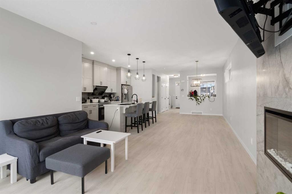 22 Edith Manor Nw, Calgary, AB - Indoor Photo Showing Living Room With Fireplace