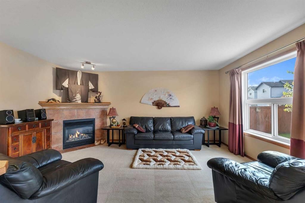 214 Saddlemont Boulevard Ne, Calgary, AB - Indoor Photo Showing Living Room With Fireplace
