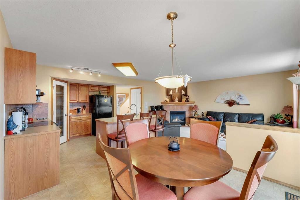 214 Saddlemont Boulevard Ne, Calgary, AB - Indoor Photo Showing Dining Room With Fireplace
