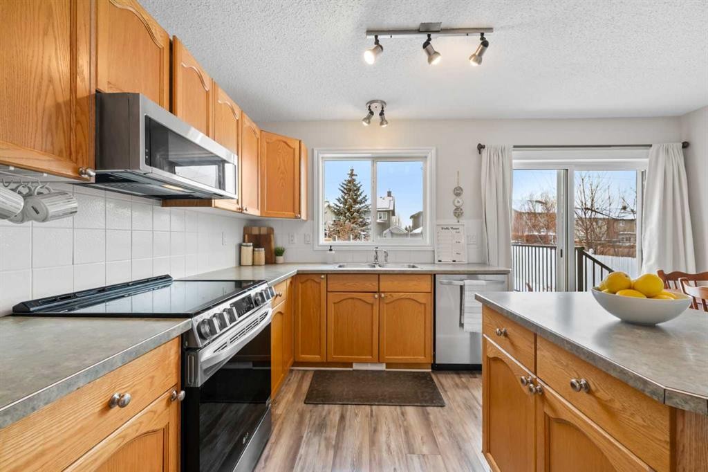 8 Chapalina Crescent Se, Calgary, AB - Indoor Photo Showing Kitchen With Double Sink