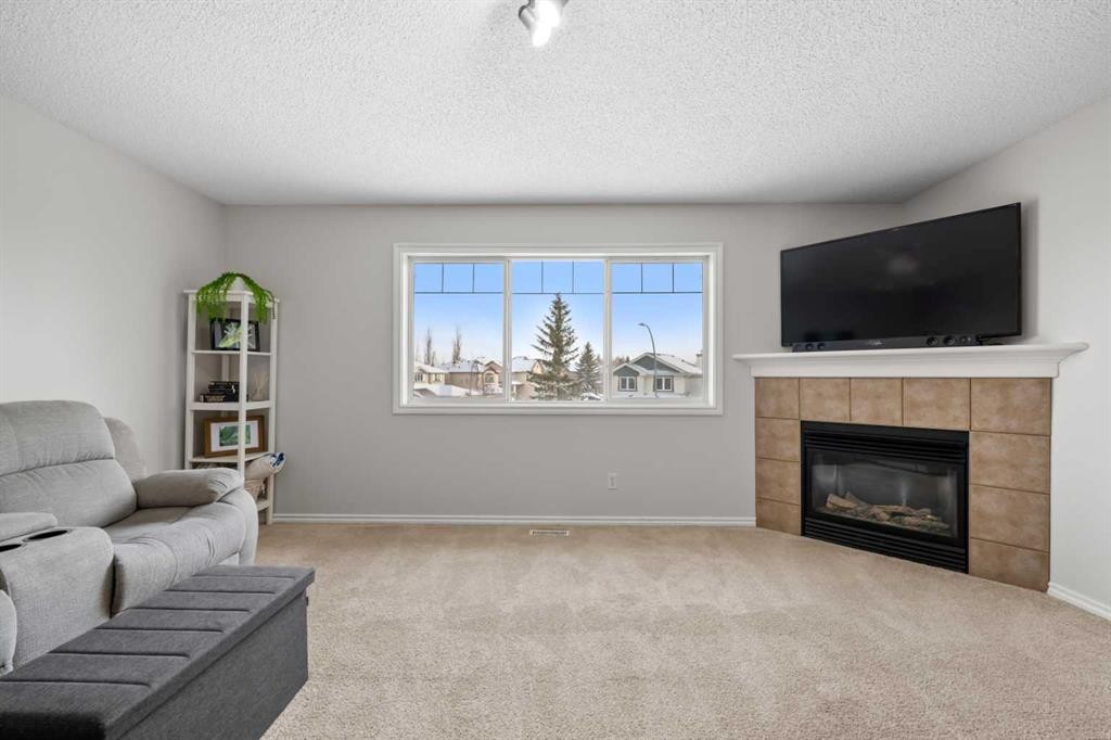 8 Chapalina Crescent Se, Calgary, AB - Indoor Photo Showing Living Room With Fireplace