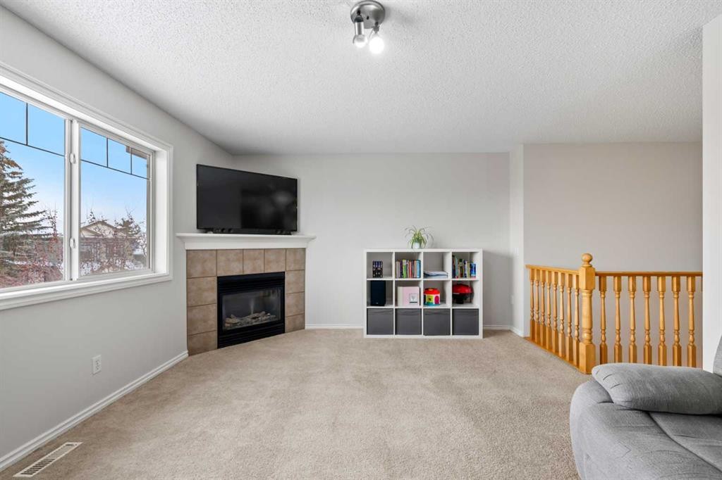 8 Chapalina Crescent Se, Calgary, AB - Indoor Photo Showing Living Room With Fireplace