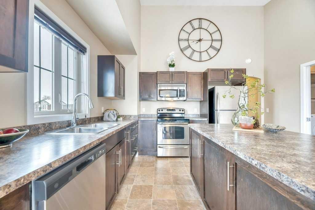 1205-230 Eversyde Boulevard Sw, Calgary, AB - Indoor Photo Showing Kitchen With Double Sink