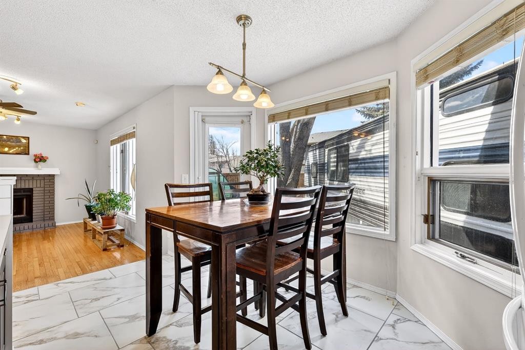 29 Sundown Way Se, Calgary, AB - Indoor Photo Showing Dining Room With Fireplace