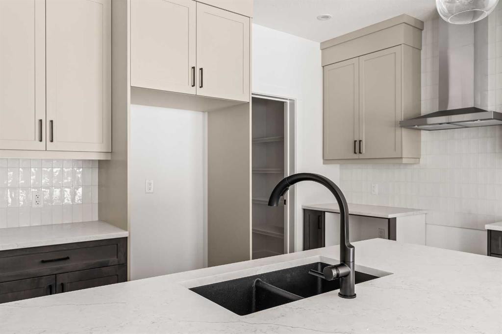 49 Starling Passage Nw, Calgary, AB - Indoor Photo Showing Kitchen With Double Sink With Upgraded Kitchen