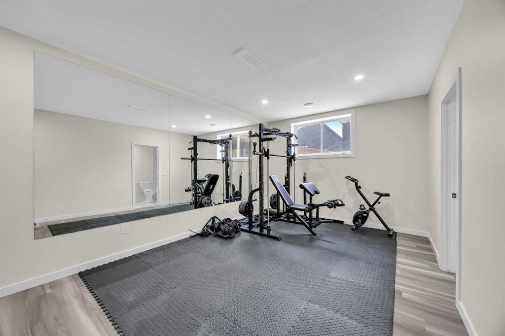 76 Edith Mews Nw, Calgary, AB - Indoor Photo Showing Gym Room