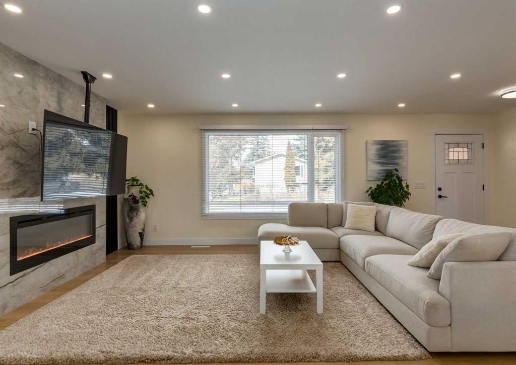 5219 Valiant Drive Nw, Calgary, AB - Indoor Photo Showing Living Room With Fireplace