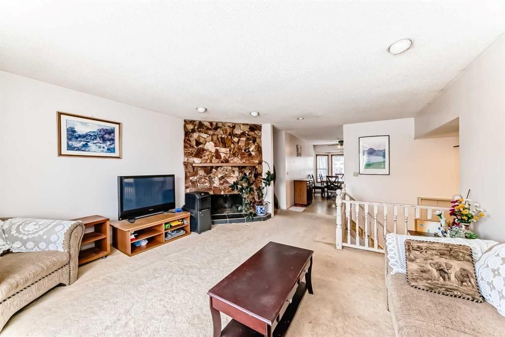224 Berwick Way Nw, Calgary, AB - Indoor Photo Showing Living Room With Fireplace