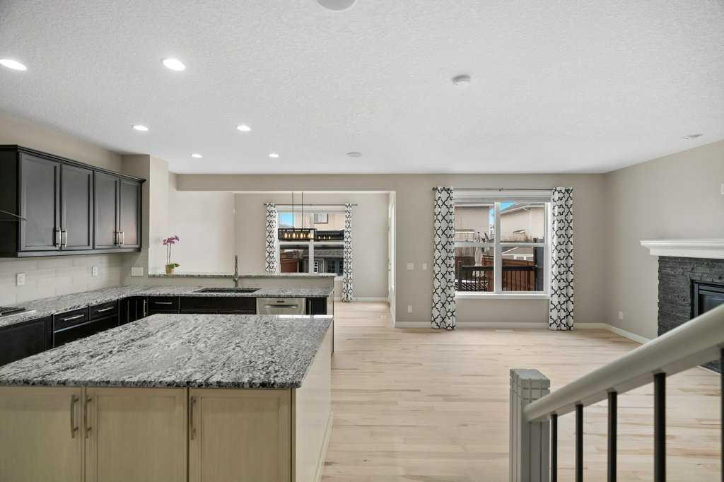 54 Auburn Crest Way Se, Calgary, AB - Indoor Photo Showing Kitchen With Fireplace