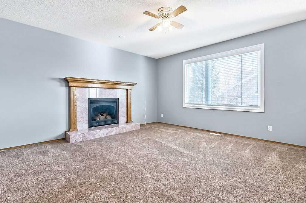 303 Schubert Place Nw, Calgary, AB - Indoor Photo Showing Other Room With Fireplace