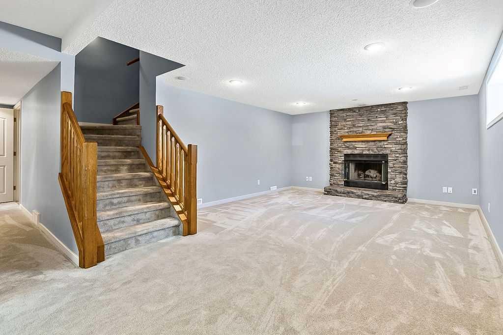 303 Schubert Place Nw, Calgary, AB - Indoor Photo Showing Living Room With Fireplace