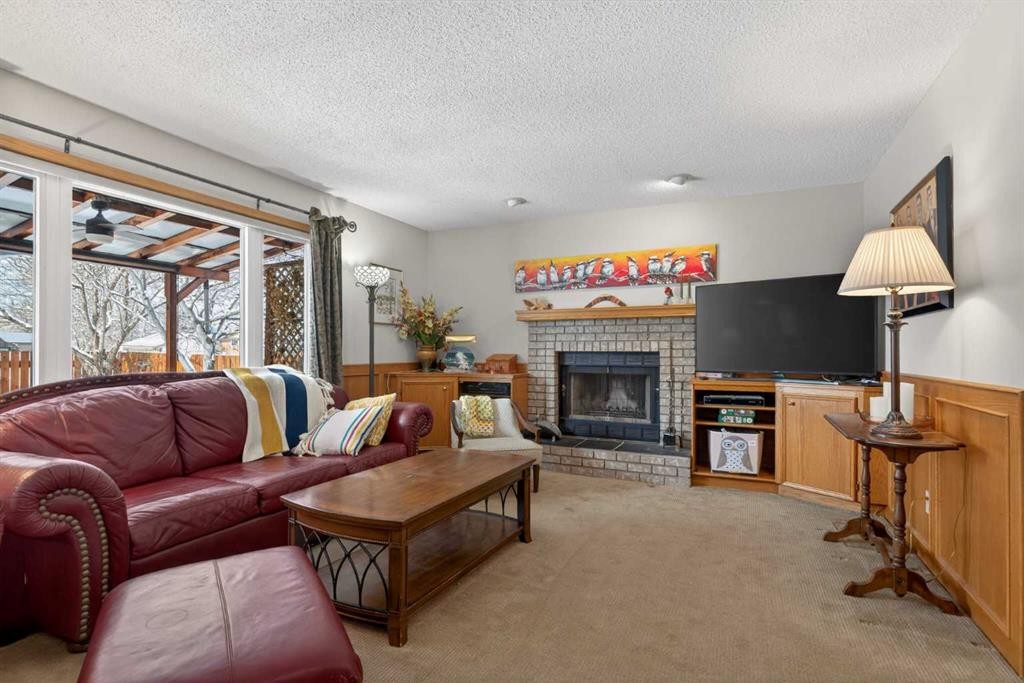 204 Sunrise Circle Se, Calgary, AB - Indoor Photo Showing Living Room With Fireplace